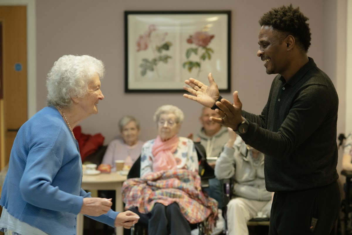 A younger man sharing a warm moment with an elderly woman